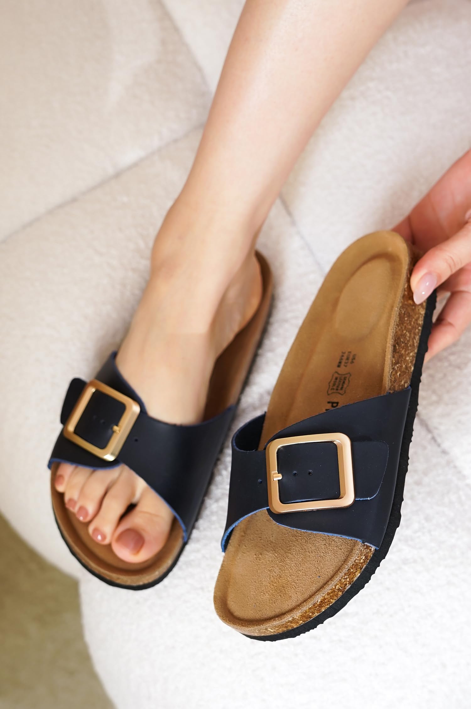 Project Cloud women's leather sandals in navy blue with gold buckle and cork footbed. Summer beach essentials.