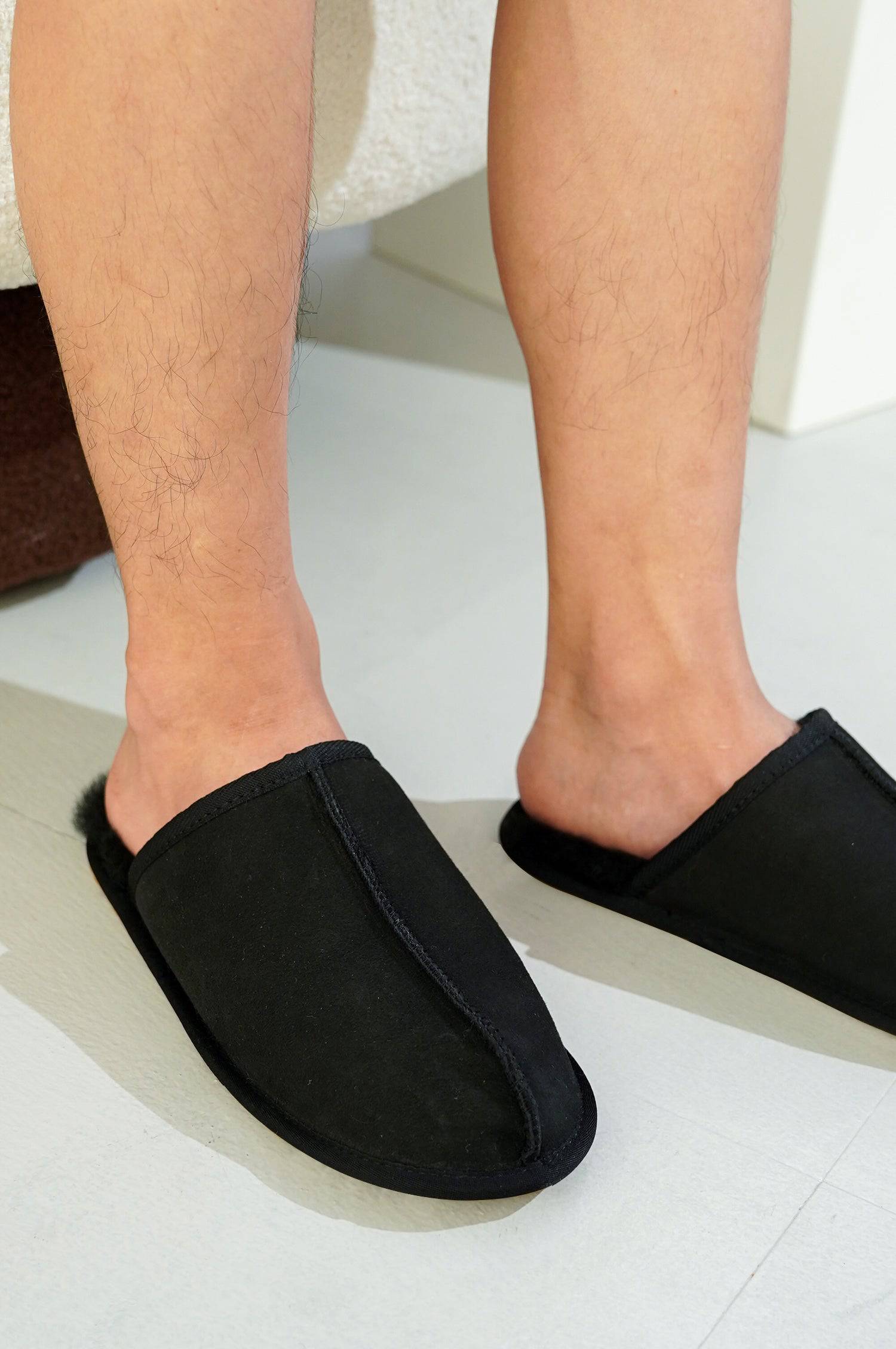 Project Cloud Colin Men's Slipper in Black: Black suede upper, sheepskin lining, memory foam, cozy comfort.