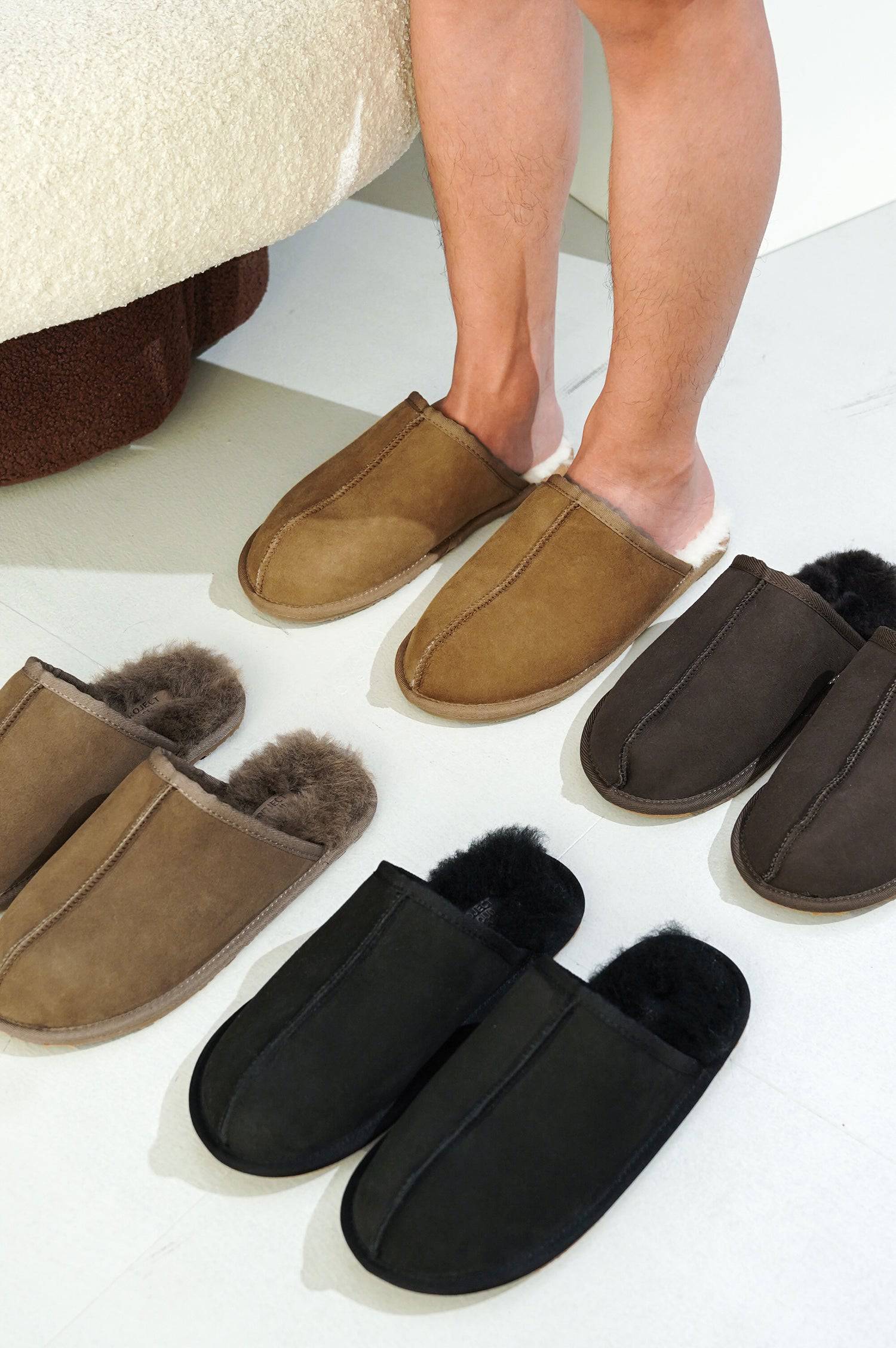 Project Cloud Colin Men's Slippers: Brown suede with sheepskin lining, and black suede slippers on display.