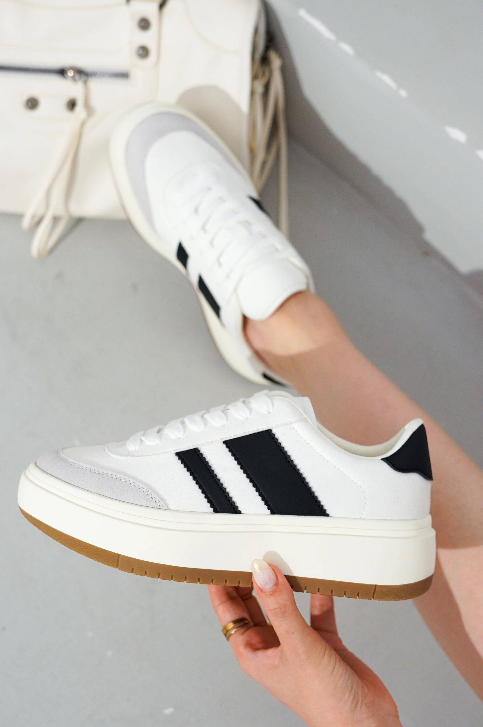 White Nita platform sneakers with black stripes, a beige sole, and lace-up design; Project Cloud women's fashion.