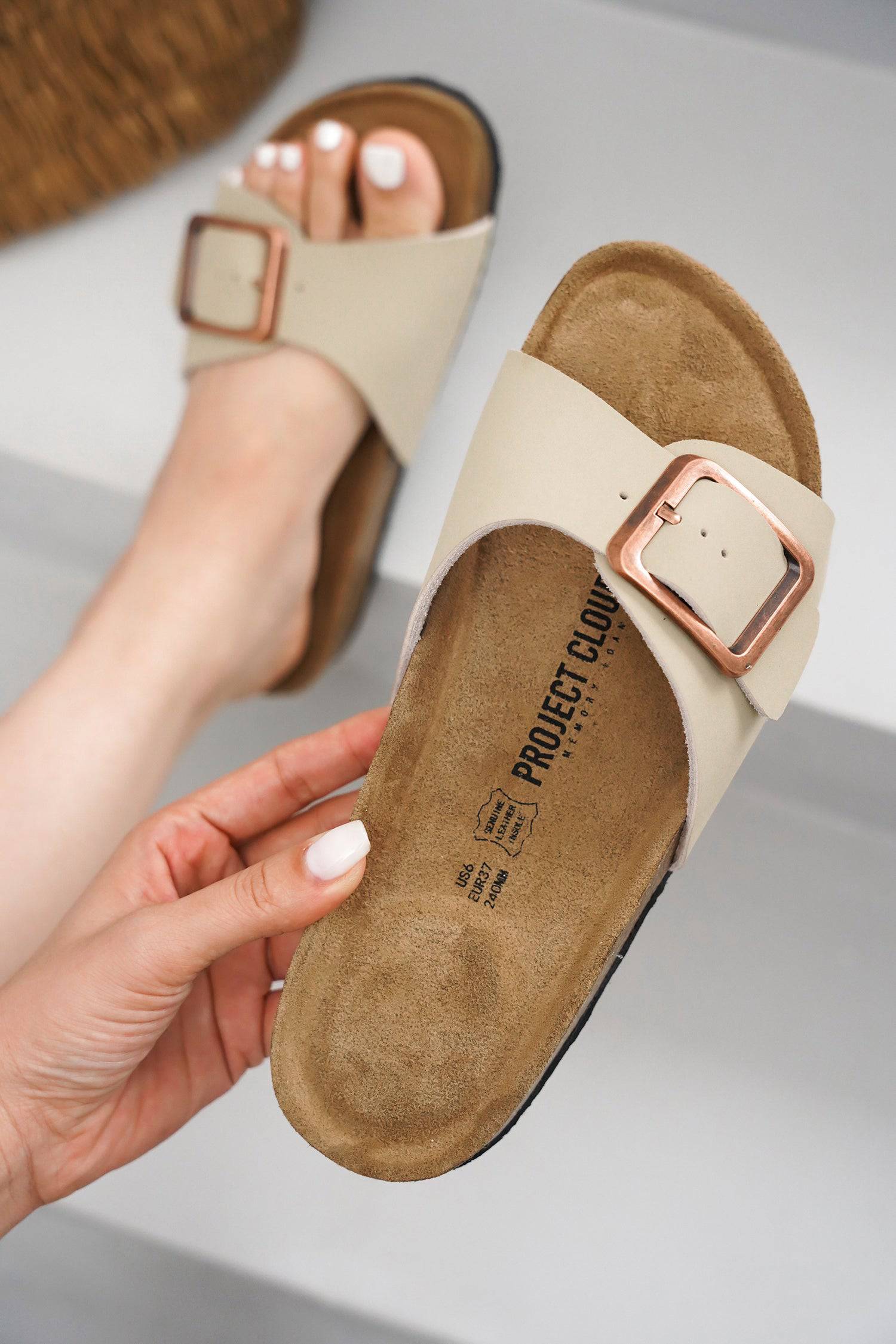 Project Cloud beige leather sandal with buckle detail, featuring genuine leather and cork footbed.