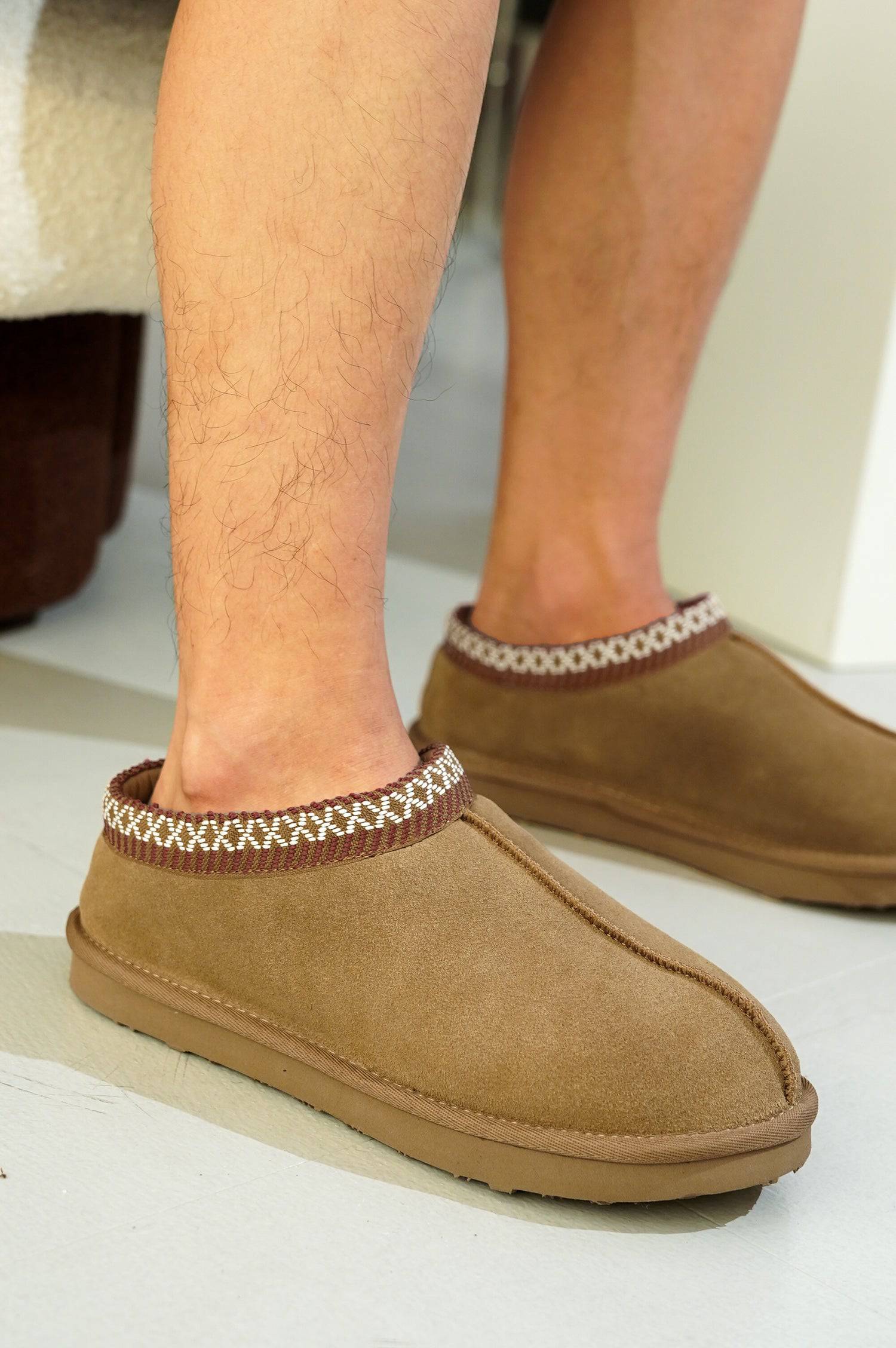 Brown suede men's Australian sheepskin slippers with trim and non-slip sole, for relaxation.