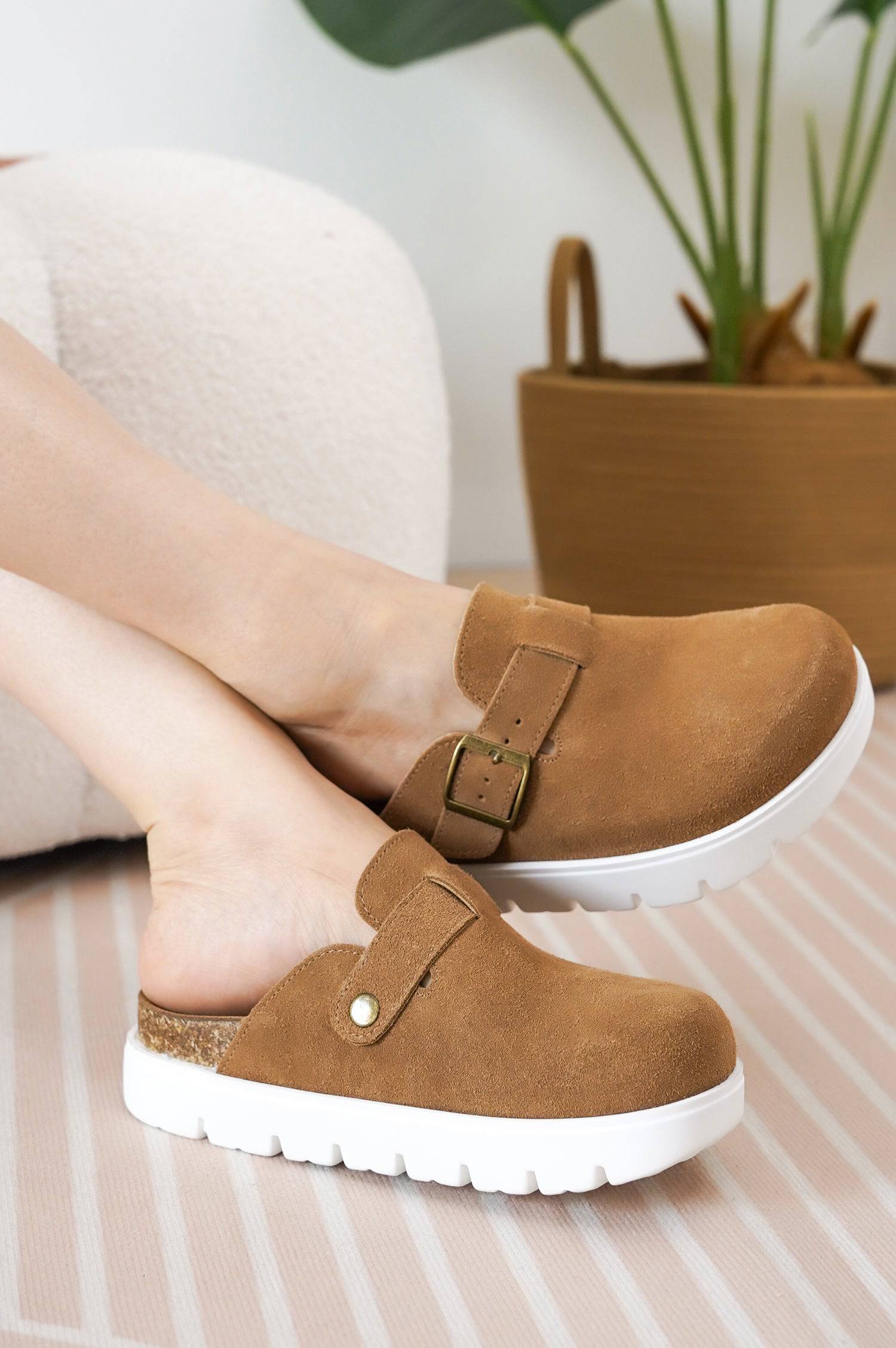 Tan suede Benton Chunky Clogs for women with buckle detail, cork footbed, and white platform sole.