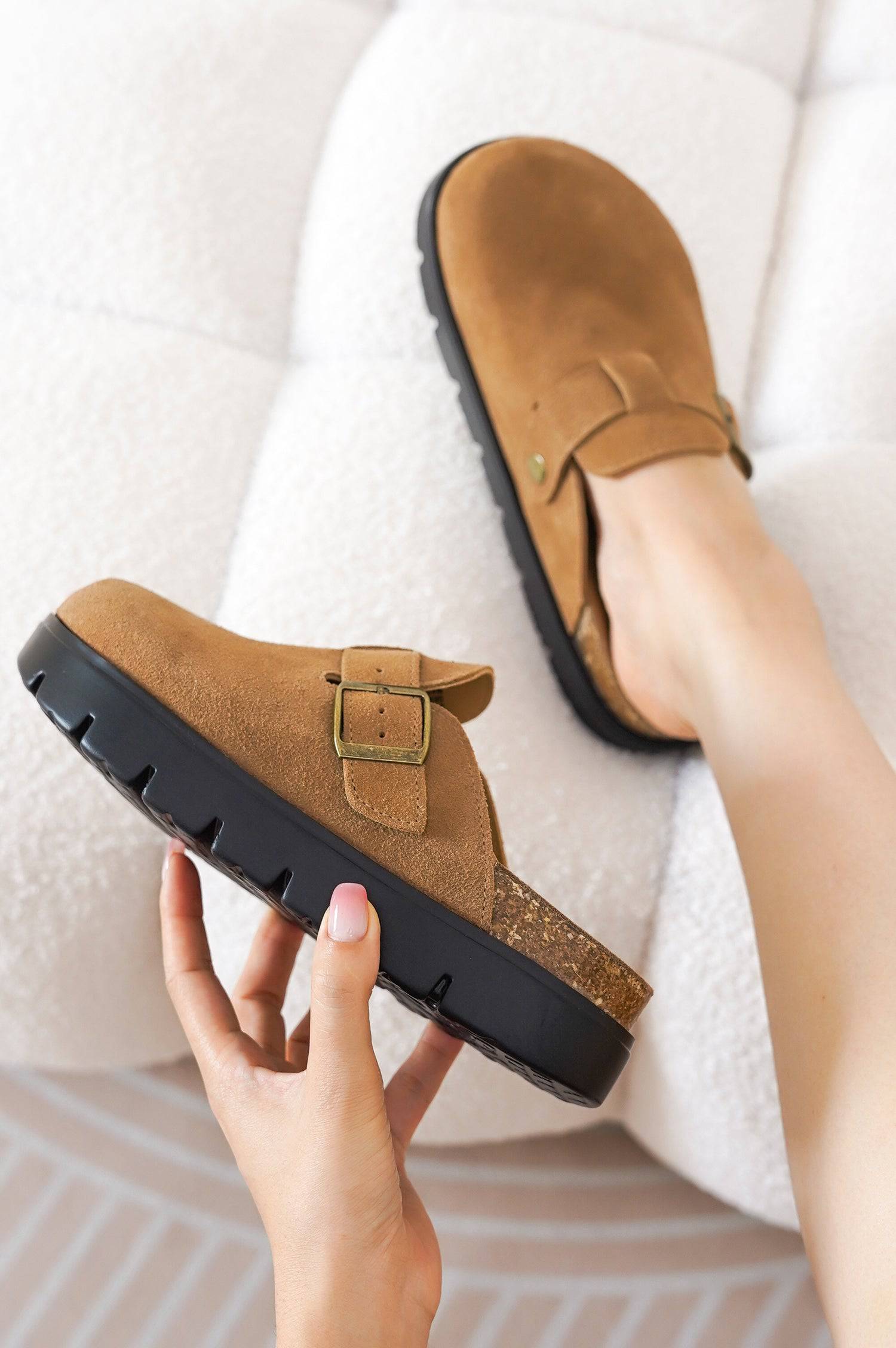 Tan suede Benton Chunky Clogs with buckle detail, cork footbed, and black platform sole for women's casual footwear.