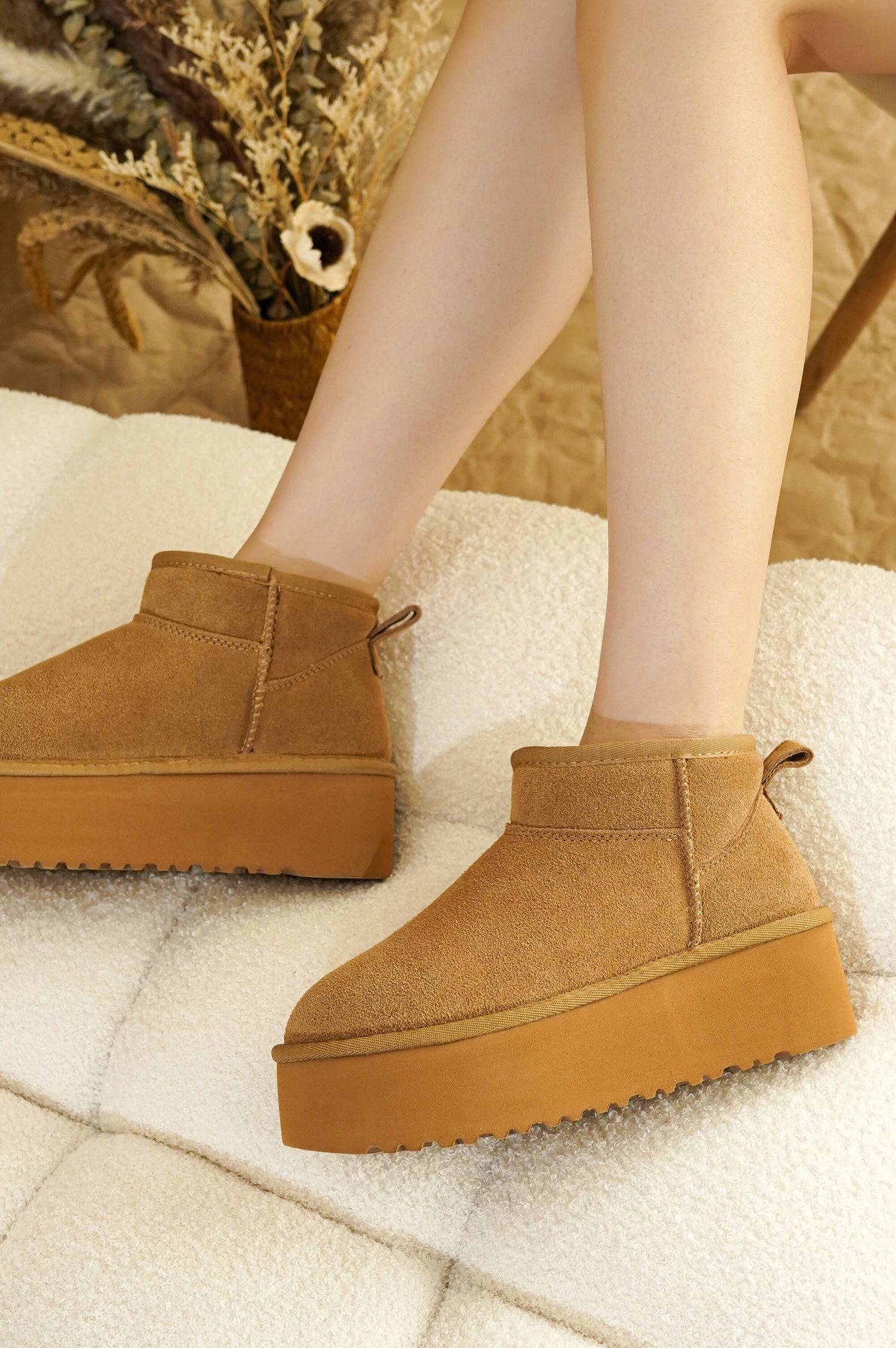 Women's brown suede Huggy ankle boots with platform sole and faux fur lining. Lightweight winter boots.