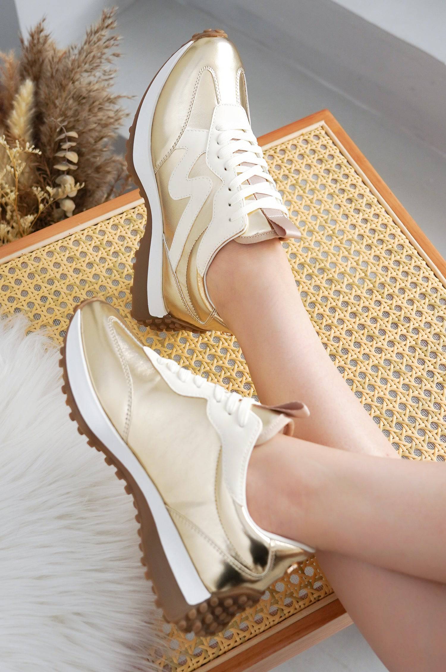 Women's gold "Lecco" sneakers with white details, canvas upper, and anti-slip sole