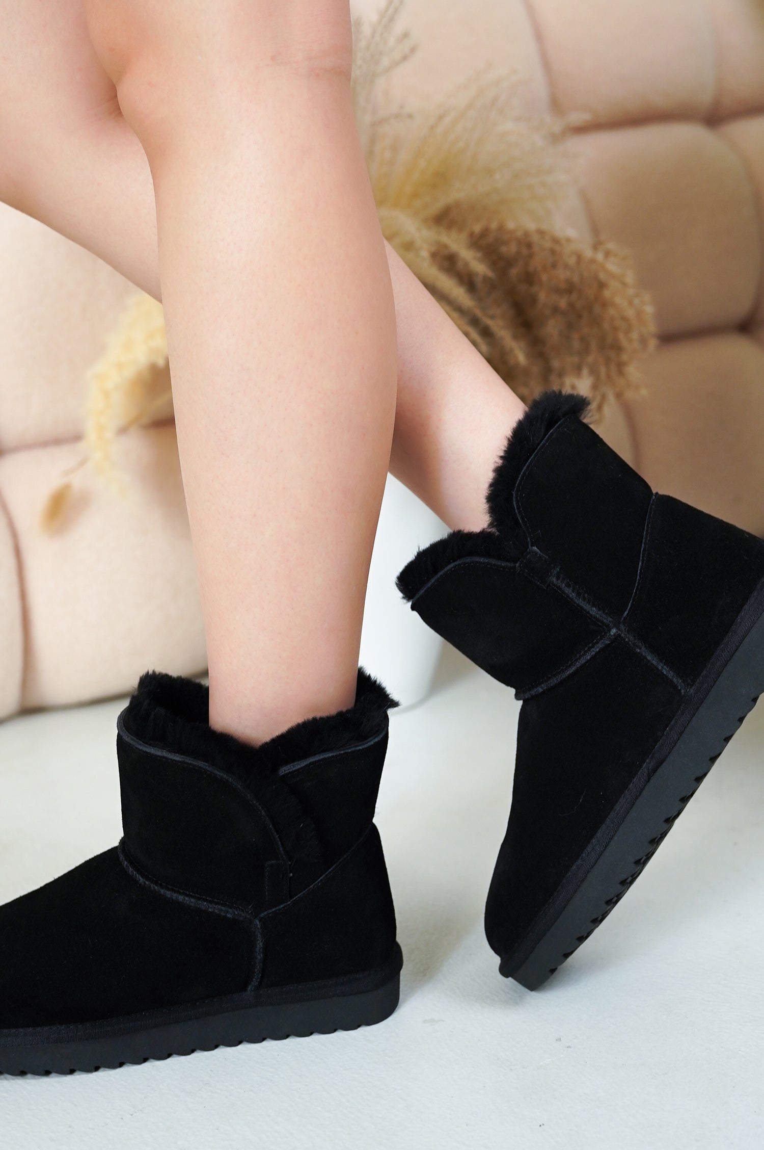 Project Cloud Timmy Mini Boots: Black suede leather ankle boots with fur lining, worn by a woman.